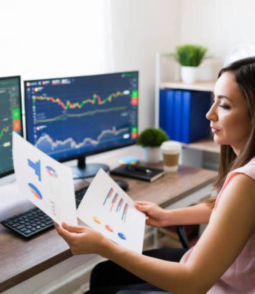 istockphoto-1332377628-612×612 Business analyst looking at a graph chart while working from home as a freelance. Professional young woman buying stocks